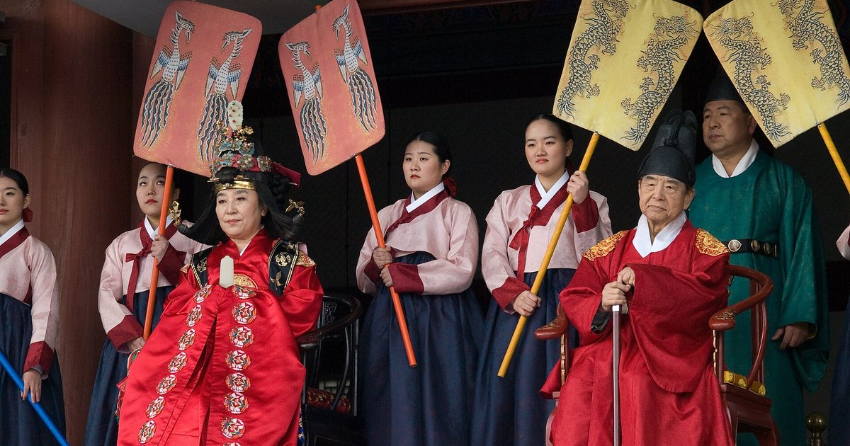 Gyeongbokgung Palace displays classical traditional architecture framed by surrounding mountain backdrops.